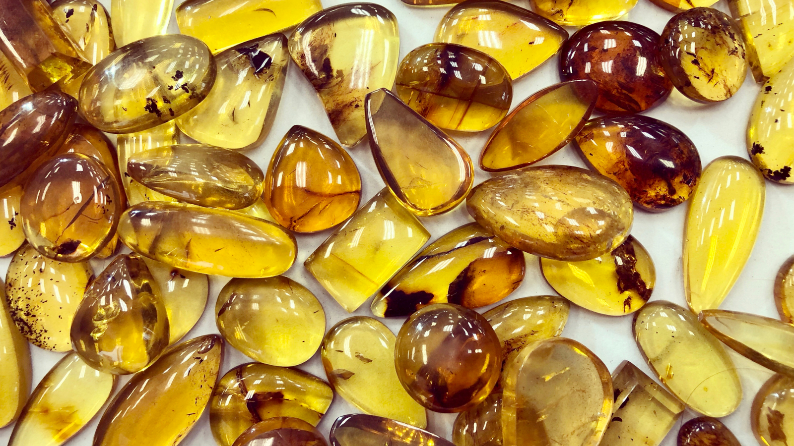 Citrine Cabochons Full frame of smooth citrine gemstone cabachons on white background